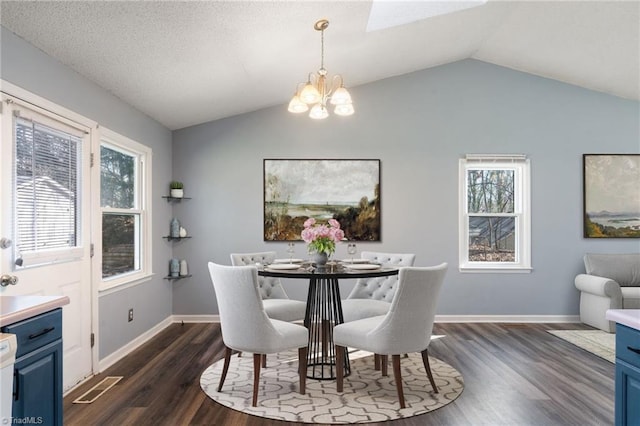 dining room featuring a notable chandelier, lofted ceiling, a textured ceiling, baseboards, and dark wood-style flooring