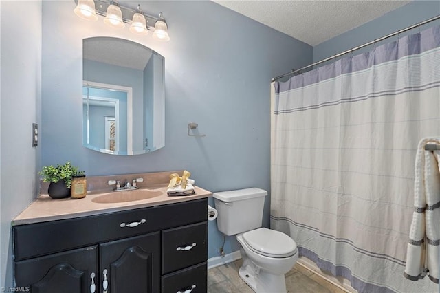 full bath with vanity, wood finished floors, baseboards, a textured ceiling, and toilet