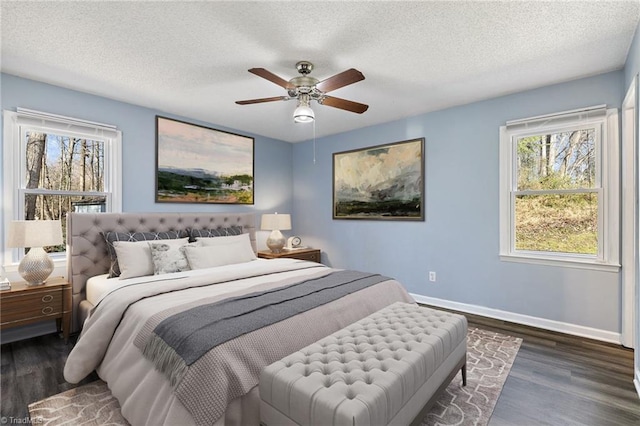 bedroom featuring ceiling fan, a textured ceiling, baseboards, and wood finished floors