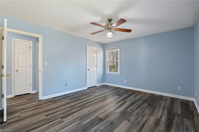 unfurnished bedroom featuring baseboards and dark wood-style floors