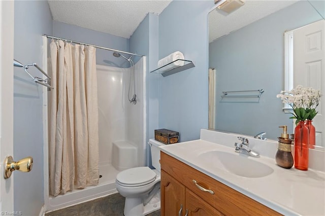 bathroom with vanity, toilet, a shower with curtain, and a textured ceiling