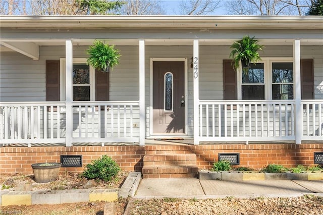 doorway to property with crawl space and a porch