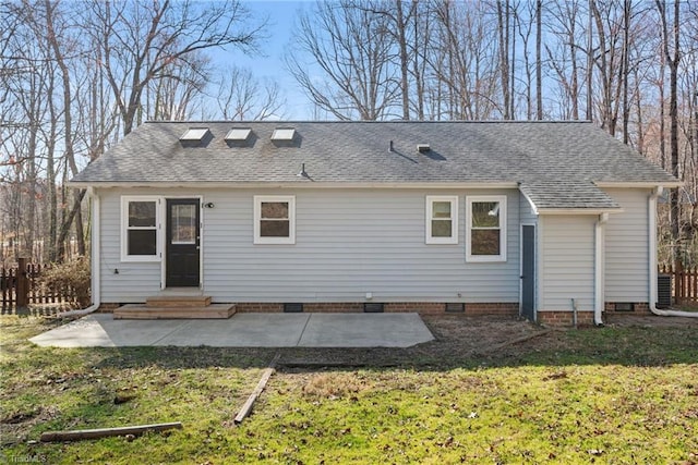 rear view of house featuring entry steps, a yard, a patio area, and crawl space