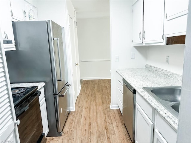 2711 Reynolds Park Rd, Winston-Salem, NC 27107 - kitchen with stainless steel dishwasher, black range with electric stovetop, light wood-type flooring, white cabinetry, and light stone counters