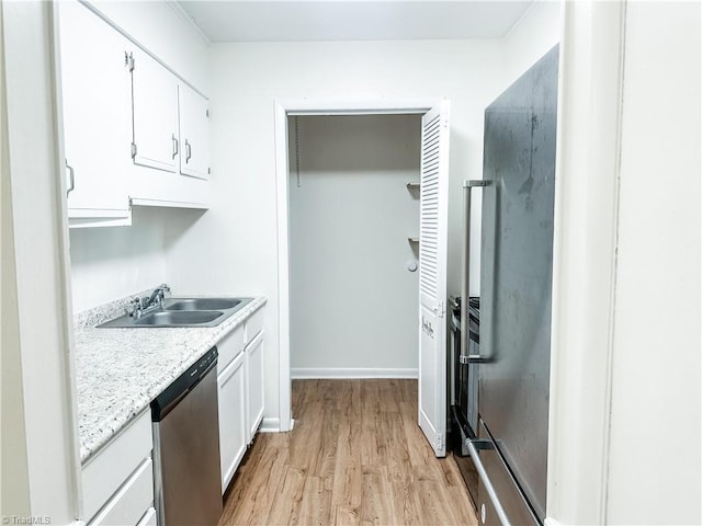 2711 Reynolds Park Rd, Winston-Salem, NC 27107 - kitchen featuring dishwasher, light wood-type flooring, white cabinets, and light countertops