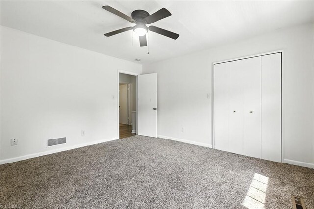 2711 Reynolds Park Rd, Winston-Salem, NC 27107 - unfurnished bedroom with carpet, a closet, and a ceiling fan