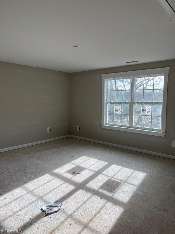 spare room featuring baseboards