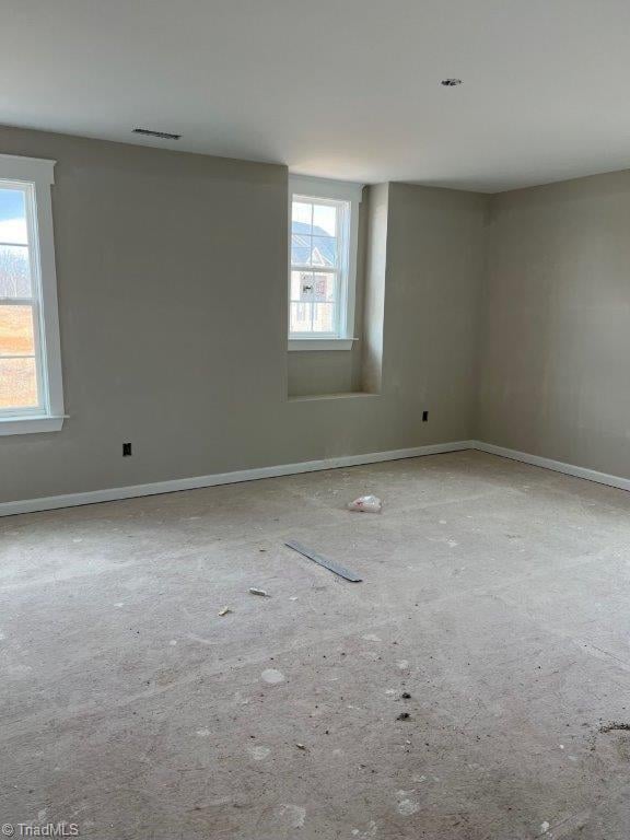 spare room with visible vents and baseboards