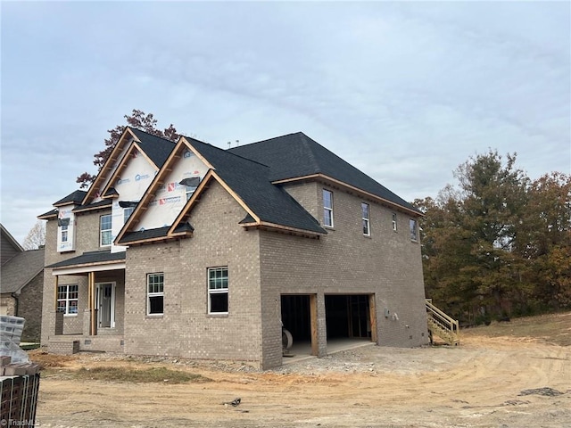 view of front of home with a garage and brick siding