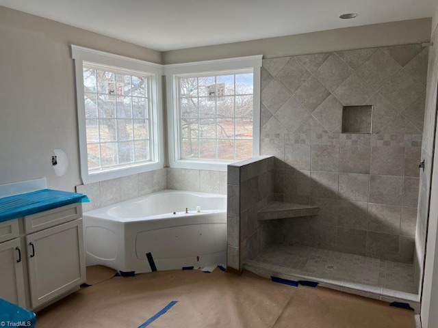 full bath featuring a bath and tiled shower