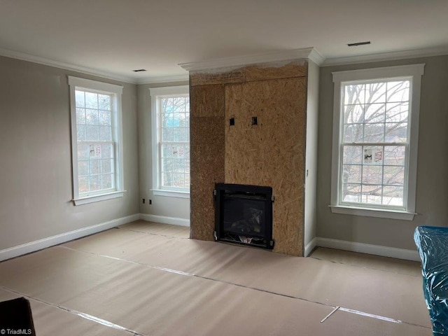 unfurnished living room featuring a glass covered fireplace, baseboards, and ornamental molding