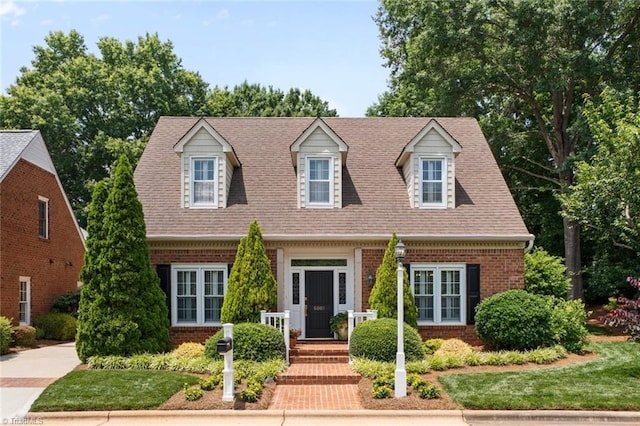6001 Rittenhouse Rd, Winston-Salem, NC 27104 - cape cod-style house featuring brick siding and roof with shingles