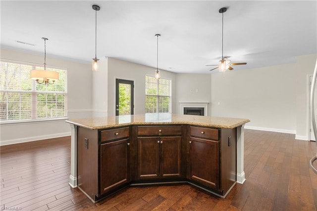 kitchen featuring baseboards, a ceiling fan, dark wood-style floors, and dark brown cabinets