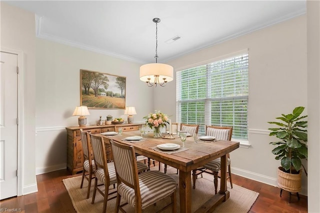 dining area with ornamental molding, baseboards, and dark wood-style floors
