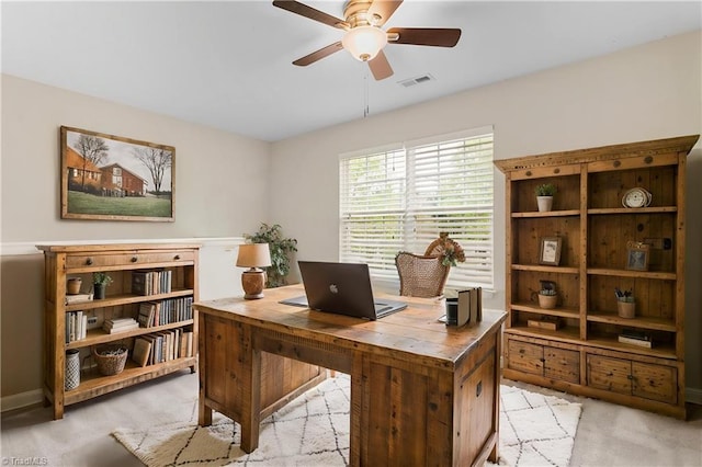home office featuring ceiling fan, visible vents, and light colored carpet