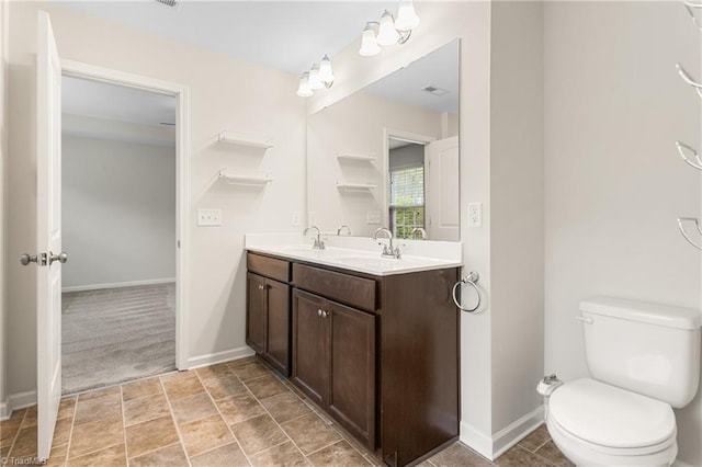 bathroom with a sink, toilet, and baseboards