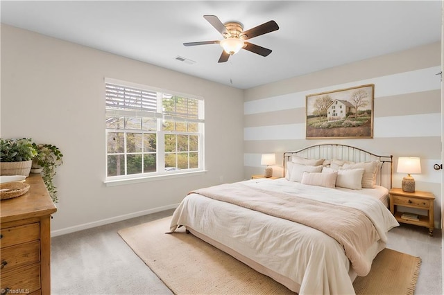 bedroom with baseboards, carpet flooring, visible vents, and a ceiling fan