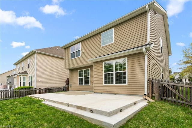 back of property with a lawn, a patio, and a fenced backyard