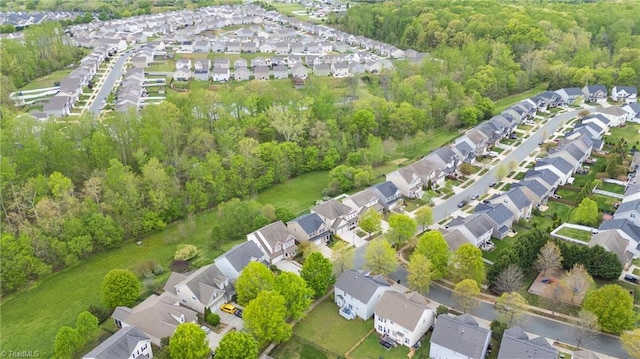 bird's eye view with a wooded view and a residential view