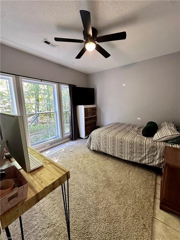 bedroom featuring a textured ceiling and ceiling fan