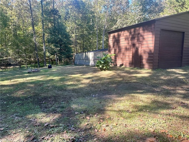 view of yard with a garage and an outdoor structure