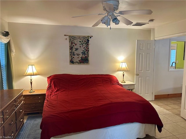 bedroom with ceiling fan and light tile patterned floors