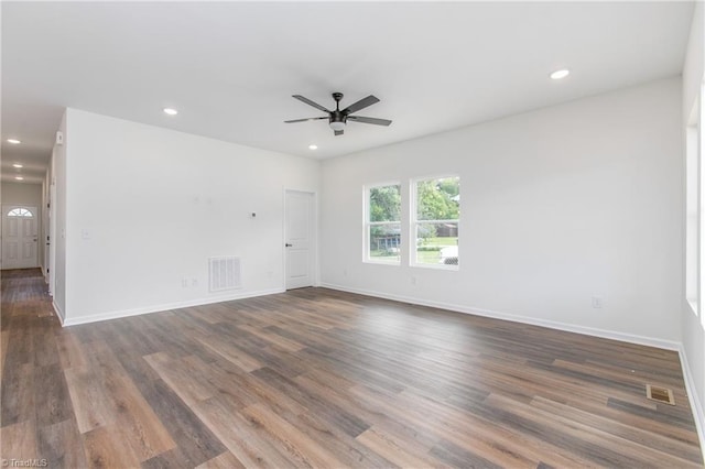 unfurnished room featuring dark wood-type flooring, visible vents, and recessed lighting