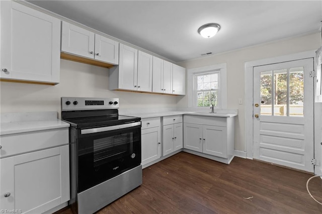 kitchen featuring white cabinets, dark hardwood / wood-style floors, stainless steel range with electric stovetop, and sink