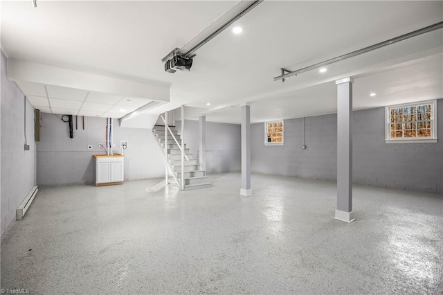 basement featuring a baseboard radiator and plenty of natural light