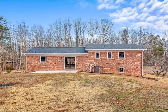 rear view of house featuring a patio, a yard, and central AC