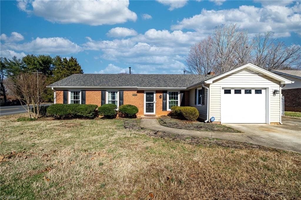 single story home with a front lawn and a garage