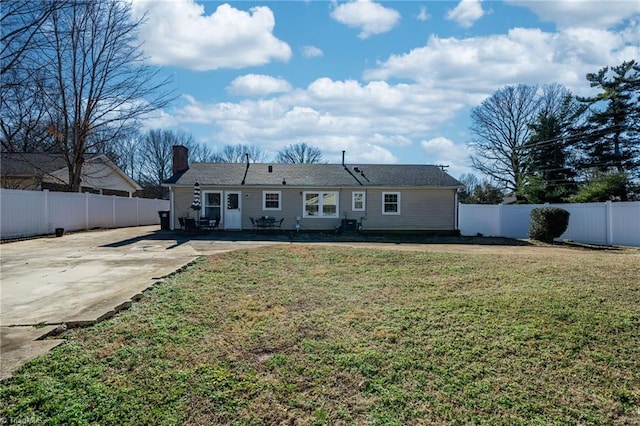 rear view of house featuring a yard and a patio