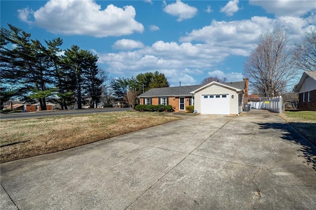 single story home featuring a garage and a front yard