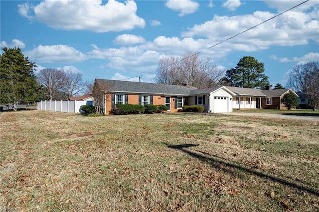 single story home featuring a front lawn and a garage