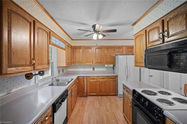 4904 Kacia Ct, Greensboro, NC 27407 - kitchen featuring ceiling fan, light wood-type flooring, a sink, black appliances, and wallpapered walls