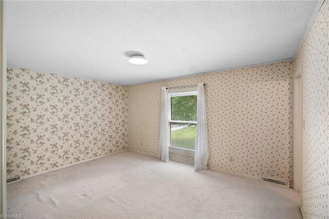 4904 Kacia Ct, Greensboro, NC 27407 - carpeted spare room featuring a textured ceiling, wallpapered walls, and visible vents