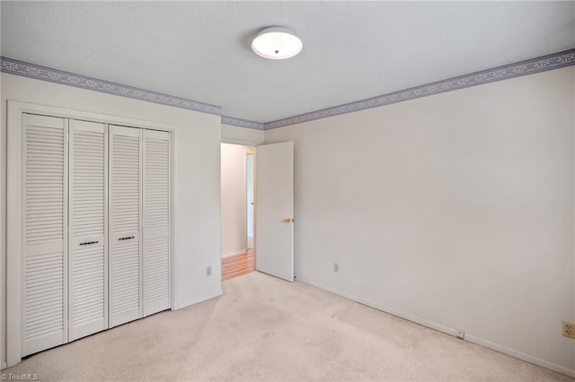 4904 Kacia Ct, Greensboro, NC 27407 - unfurnished bedroom featuring baseboards, ornamental molding, carpet, and a closet