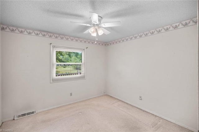 4904 Kacia Ct, Greensboro, NC 27407 - empty room with light carpet, a ceiling fan, a textured ceiling, and visible vents