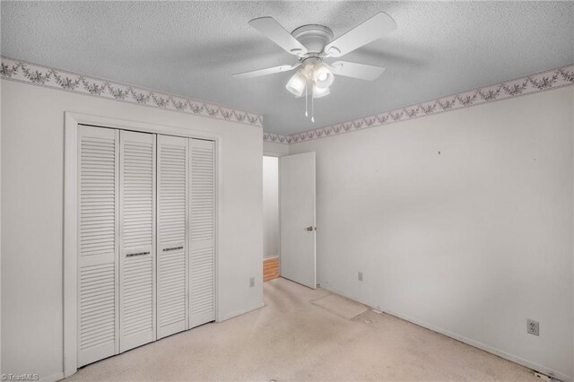 4904 Kacia Ct, Greensboro, NC 27407 - unfurnished bedroom with carpet floors, ceiling fan, a closet, and a textured ceiling