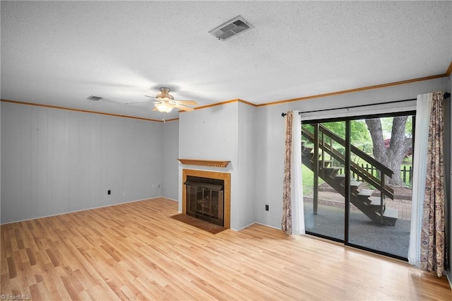 4904 Kacia Ct, Greensboro, NC 27407 - unfurnished living room with ceiling fan, visible vents, crown molding, a fireplace with flush hearth, and wood finished floors