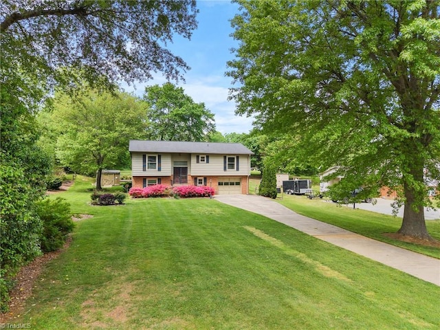 4904 Kacia Ct, Greensboro, NC 27407 - bi-level home with brick siding, an attached garage, driveway, and a front yard