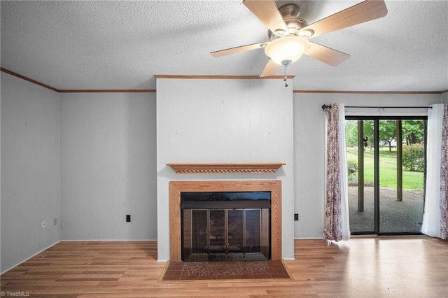 4904 Kacia Ct, Greensboro, NC 27407 - unfurnished living room featuring a fireplace with flush hearth, ornamental molding, a textured ceiling, and wood finished floors