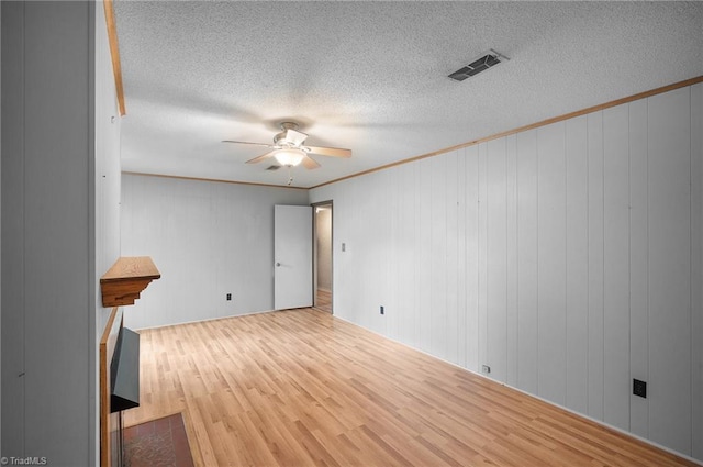 4904 Kacia Ct, Greensboro, NC 27407 - unfurnished room with a ceiling fan, a textured ceiling, visible vents, wood finished floors, and ornamental molding