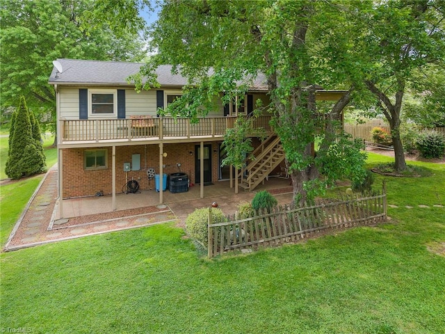 4904 Kacia Ct, Greensboro, NC 27407 - rear view of house with a lawn, a wooden deck, a patio area, central air condition unit, and brick siding
