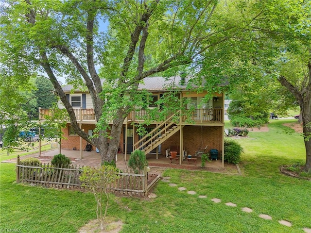 4904 Kacia Ct, Greensboro, NC 27407 - rear view of property featuring a wooden deck, brick siding, a yard, a patio, and stairs