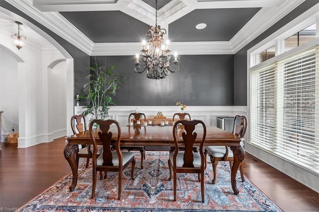 dining space with dark wood-type flooring, a wealth of natural light, a chandelier, and crown molding