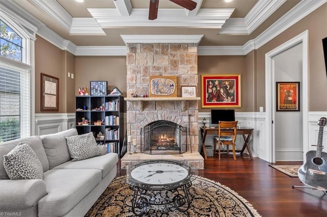 living room with ornamental molding, a fireplace, dark hardwood / wood-style flooring, and ceiling fan