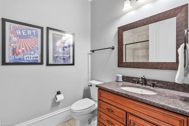 bathroom with toilet, vanity, tile patterned flooring, and walk in shower