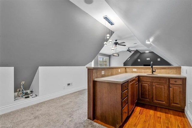 unfurnished office featuring light wood-type flooring, lofted ceiling, sink, and ceiling fan