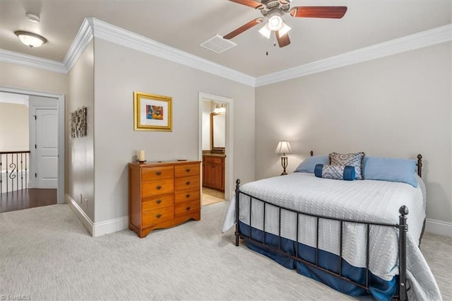 bedroom featuring ornamental molding, light colored carpet, ceiling fan, and ensuite bath